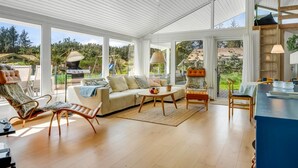 A spacious living area with a large window, a sofa, a coffee table, and a dining table. - "Gladis" - 900m from the sea by Interhome (Saltum)