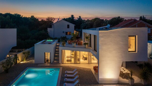 A modern two-story house with a swimming pool, outdoor seating, and a staircase leading to the upper level.
