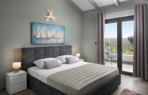 A modern bedroom with a large bed, a painting of sailboats, a star ceiling light, and a balcony with curtains.