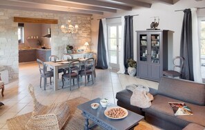 Relax in a well-appointed living space with a dining area, comfortable sofa, and kitchenette.