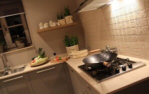 Enjoy cooking in this well-equipped kitchen with a gas stove, sink, and ample counter space.