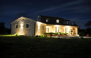 Guests can enjoy a welcoming atmosphere on the covered porch with outdoor seating.