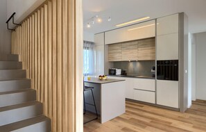 Enjoy cooking in this well-equipped kitchen with a central island and modern appliances.