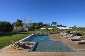 Outdoor pool, a heated pool, pool umbrellas, pool loungers