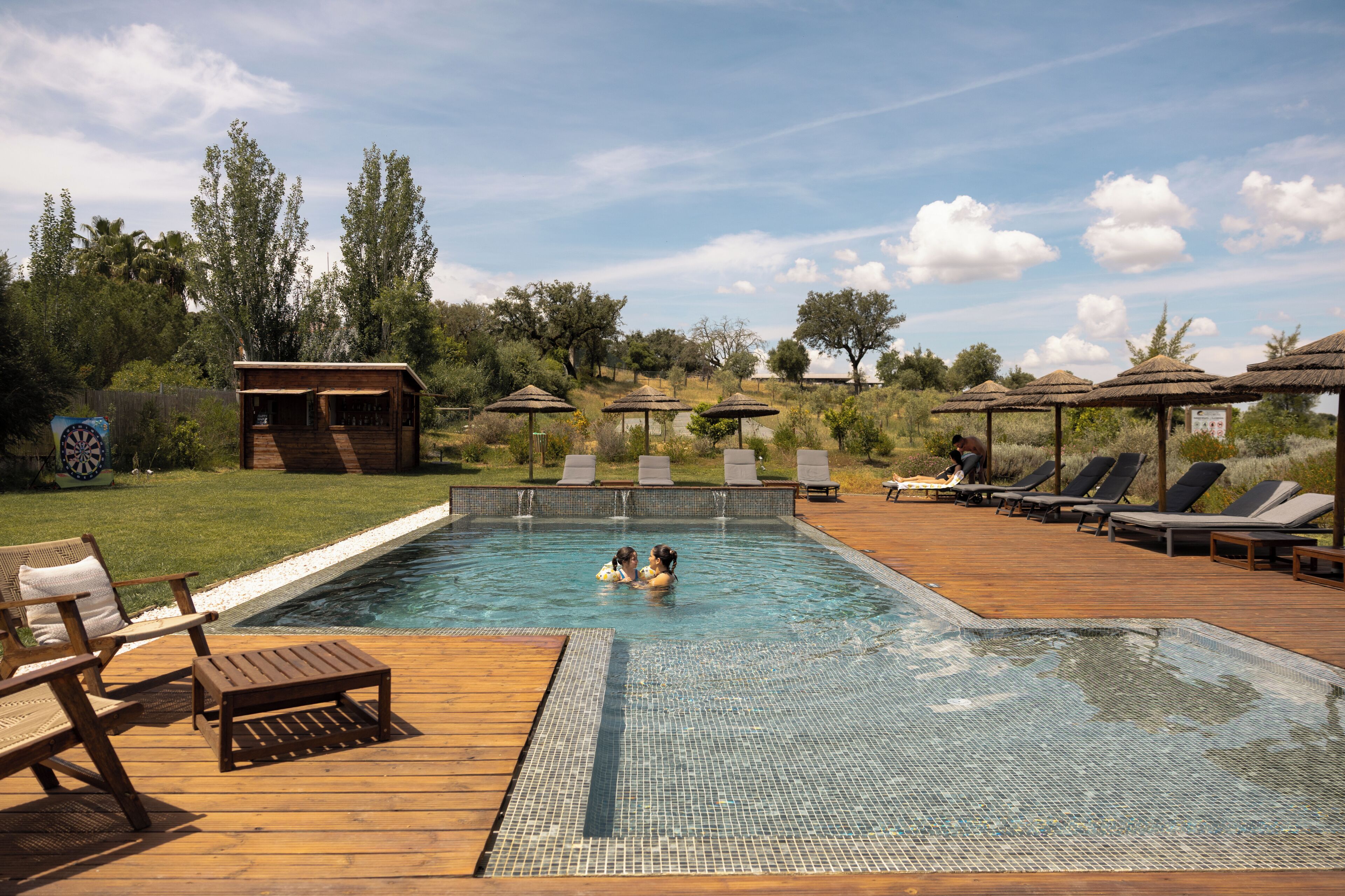 Una piscina al aire libre, una piscina climatizada, sombrillas, tumbonas