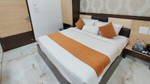 A hotel room with a bed, nightstands, and a wardrobe. - Hotel A Star-50m away from Golden Temple (Amritsar)