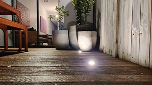 A wooden deck with large planters and a bench.