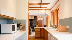 A modern kitchen with wooden cabinets, a white countertop, and a built-in dishwasher. - Langrick -  a bungalow that sleeps 10 guests  in 5 bedrooms (Nethy Bridge)