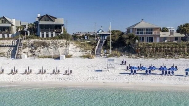 A beachfront property with multiple houses, a sandy beach, and clear blue water. - Cabana Banana - 4 Bikes / 6-Seater Golf Cart (Santa Rosa Beach)