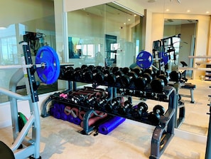 A gym with weightlifting equipment, including dumbbells and barbells. - Ailla Yalıkavak (Bodrum)