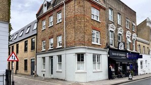 A corner building with a shop named "Band of Barbers" on the ground floor. - The Ravenscourt Park Escape - Bright 2bdr Flat (London)