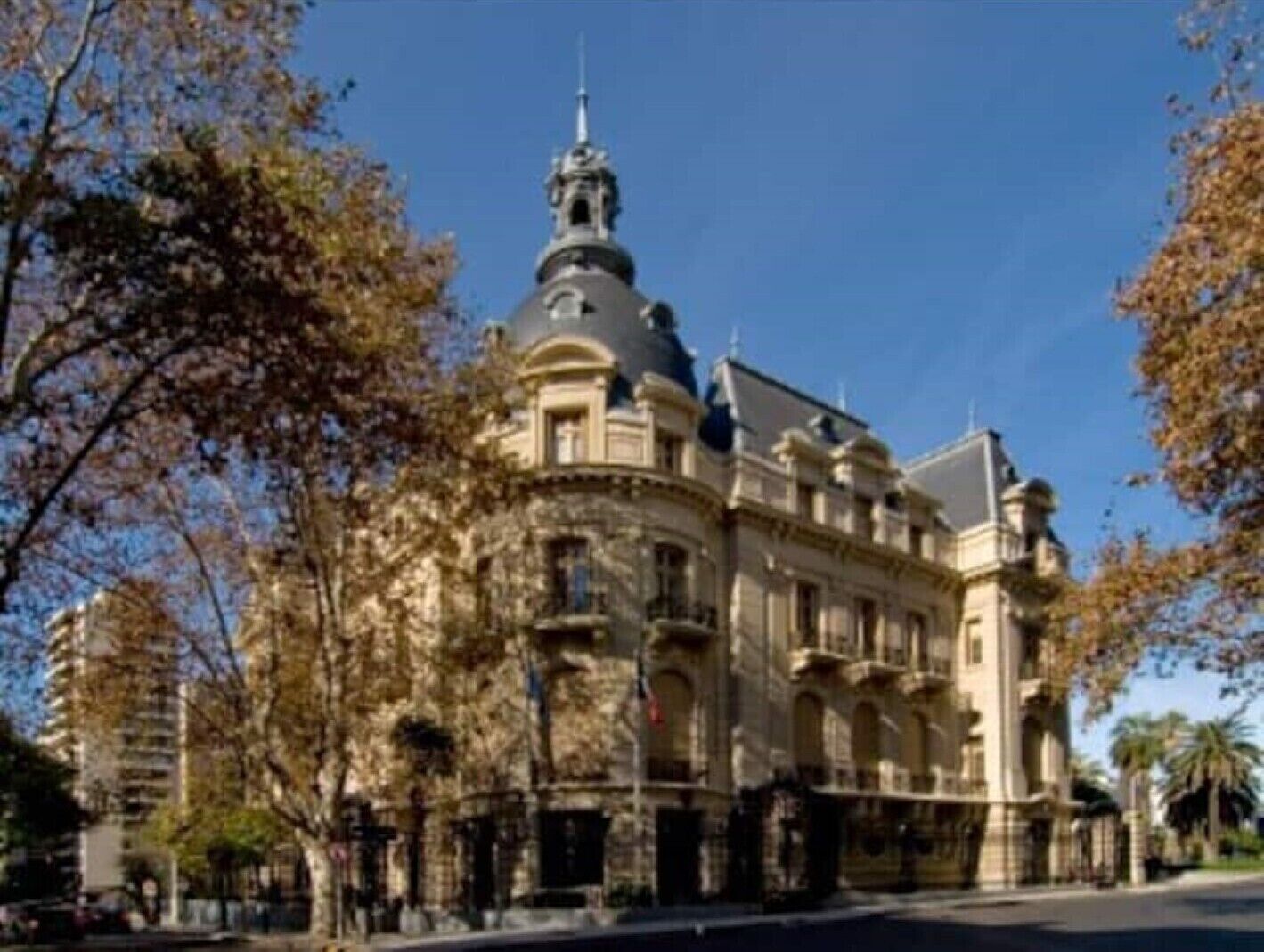 A historic building with classical architecture, featuring a prominent dome and arched windows.