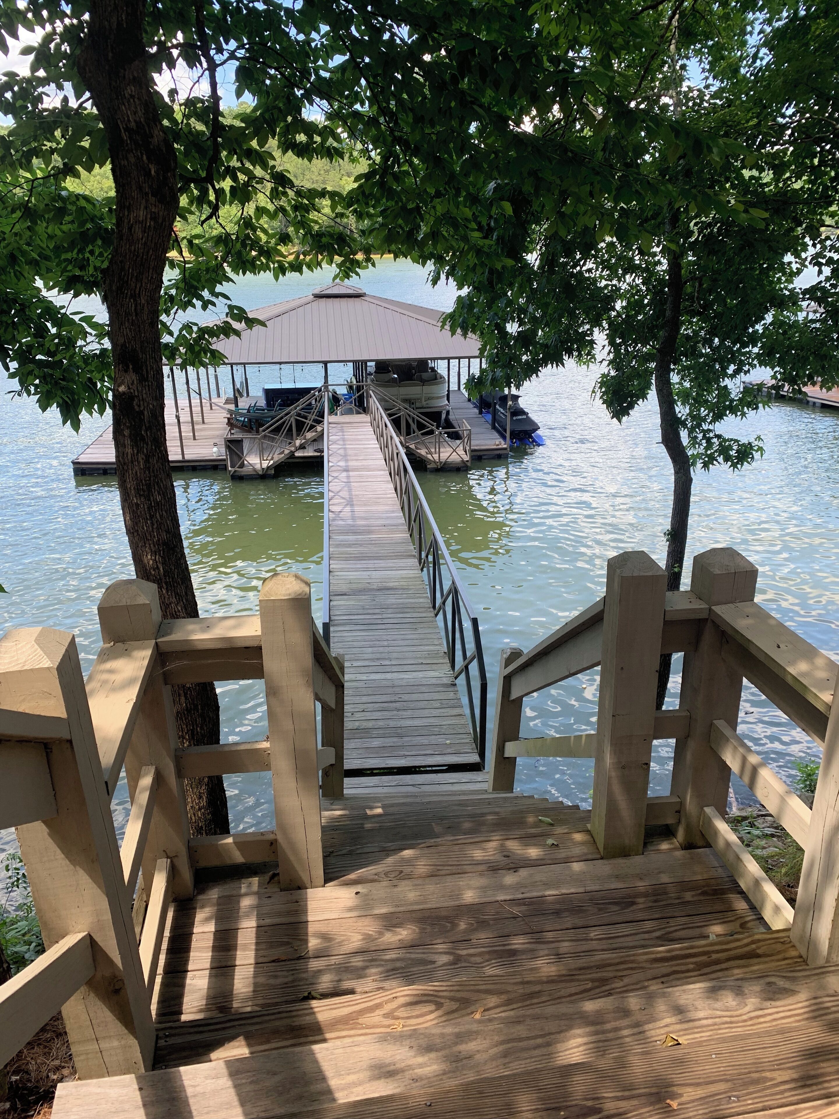 Stunning Lake home with private dock, covered parking and sweeping water views. 