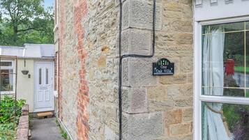 A stone building with a sign reading "One Oak Villa."