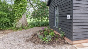 A building with a sign reading 'The Dairy,' surrounded by a gravel path and greenery. - 2 bedroom accommodation in Beauworth, near Alresford (Beauworth, near Alresford)