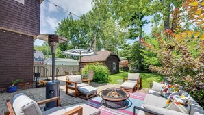 A patio with outdoor furniture, a fire pit, and a pergola.