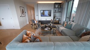 Relax in this stylish living room with a sofa, coffee table, side table, and flat-screen TV.