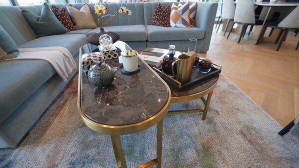 Relax in this stylish living room with a sofa, coffee table, and decorative accents.