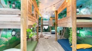 A room with bunk beds, a hammock, and a mural of a forest. - Disney, Orlando, Treehouse, Arcade, Pool, Hot Tub! (Davenport)