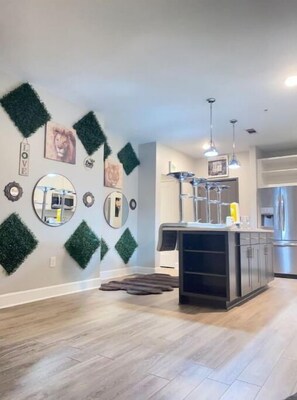 Enjoy cooking in this well-equipped kitchen with a central island, stainless steel appliances, and ample storage.