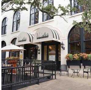 Experience the charm of Vic's River, a classic riverside eatery with arched windows and outdoor seating.
