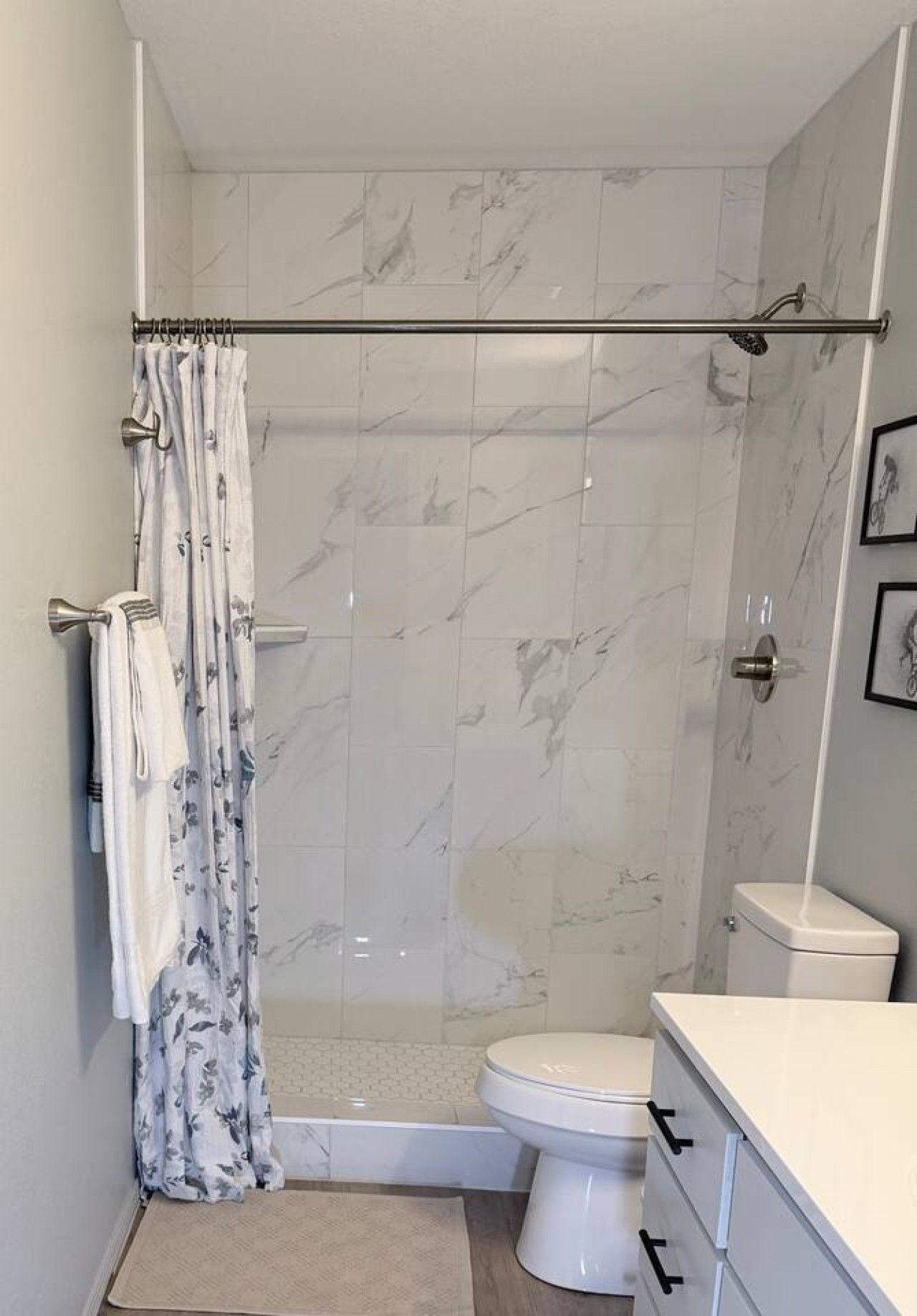 A bathroom with a shower, toilet, and a sink.