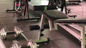 A gym with stationary bikes, treadmills, and weightlifting equipment.