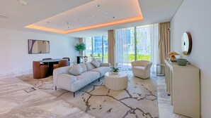 A modern living room with a sectional sofa, a coffee table, and a dining area. - Luxury StayCation - Incredible Sea View Apartment With Balcony (Dubai)