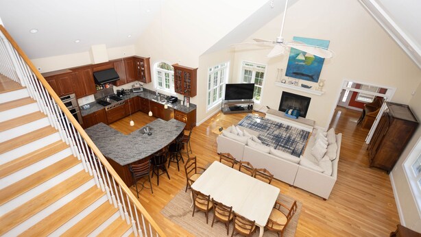A spacious living area with a kitchen, dining table, and a fireplace.