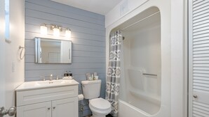 A bathroom with a white sink, toilet, and bathtub. - Dragonfly Landing: Close to Everything (Daytona Beach)