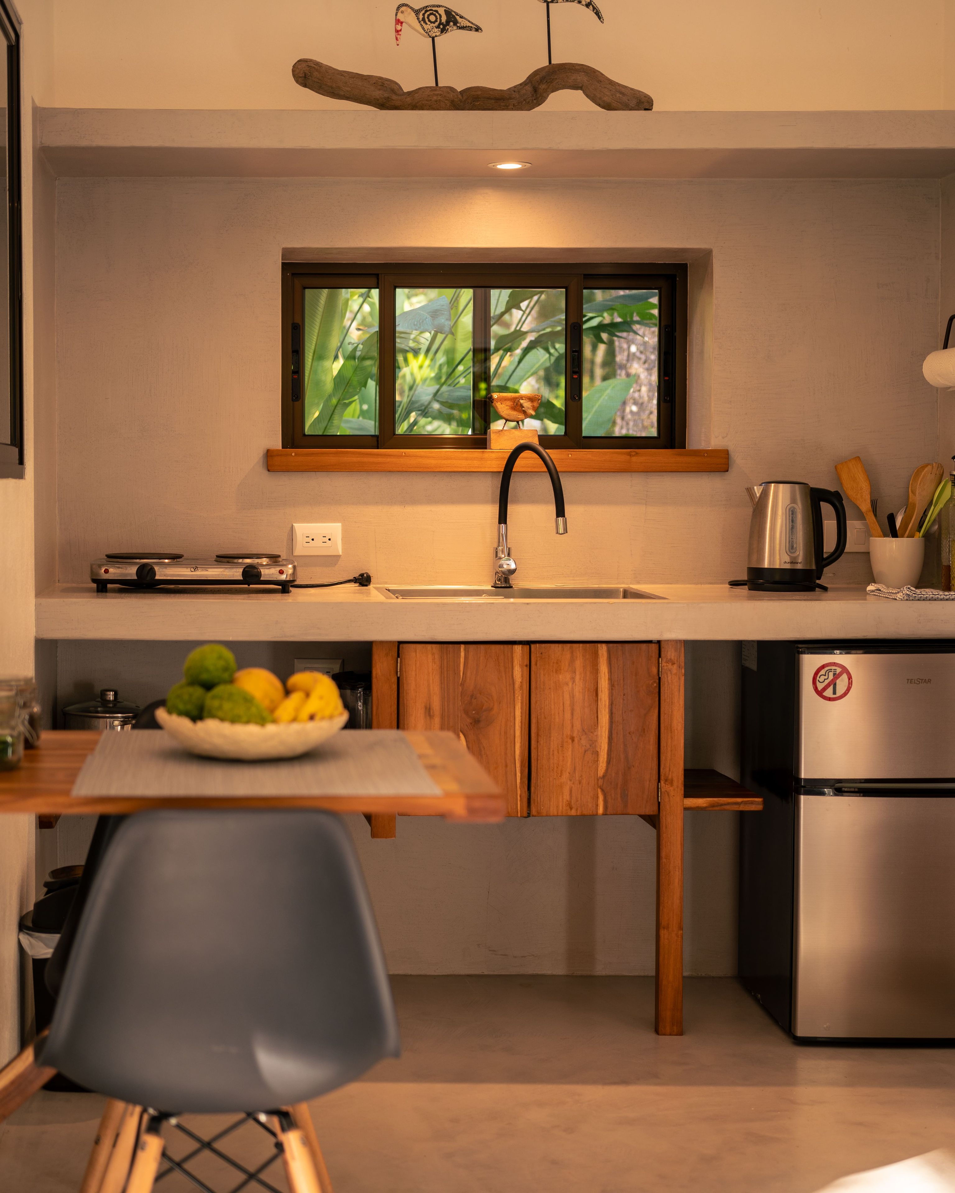 A modern kitchen with a built-in stove, a sink, and a refrigerator.