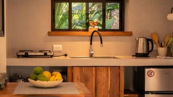 A modern kitchen with a built-in stove, a sink, and a refrigerator.