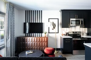 Suite, 1 King Bed with Sofa bed | Living area | 50-inch Smart TV with cable channels