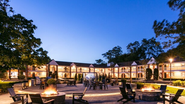 A hotel with outdoor seating, fire pits, and a well-lit facade. -  The Cove At Salem (Salem)