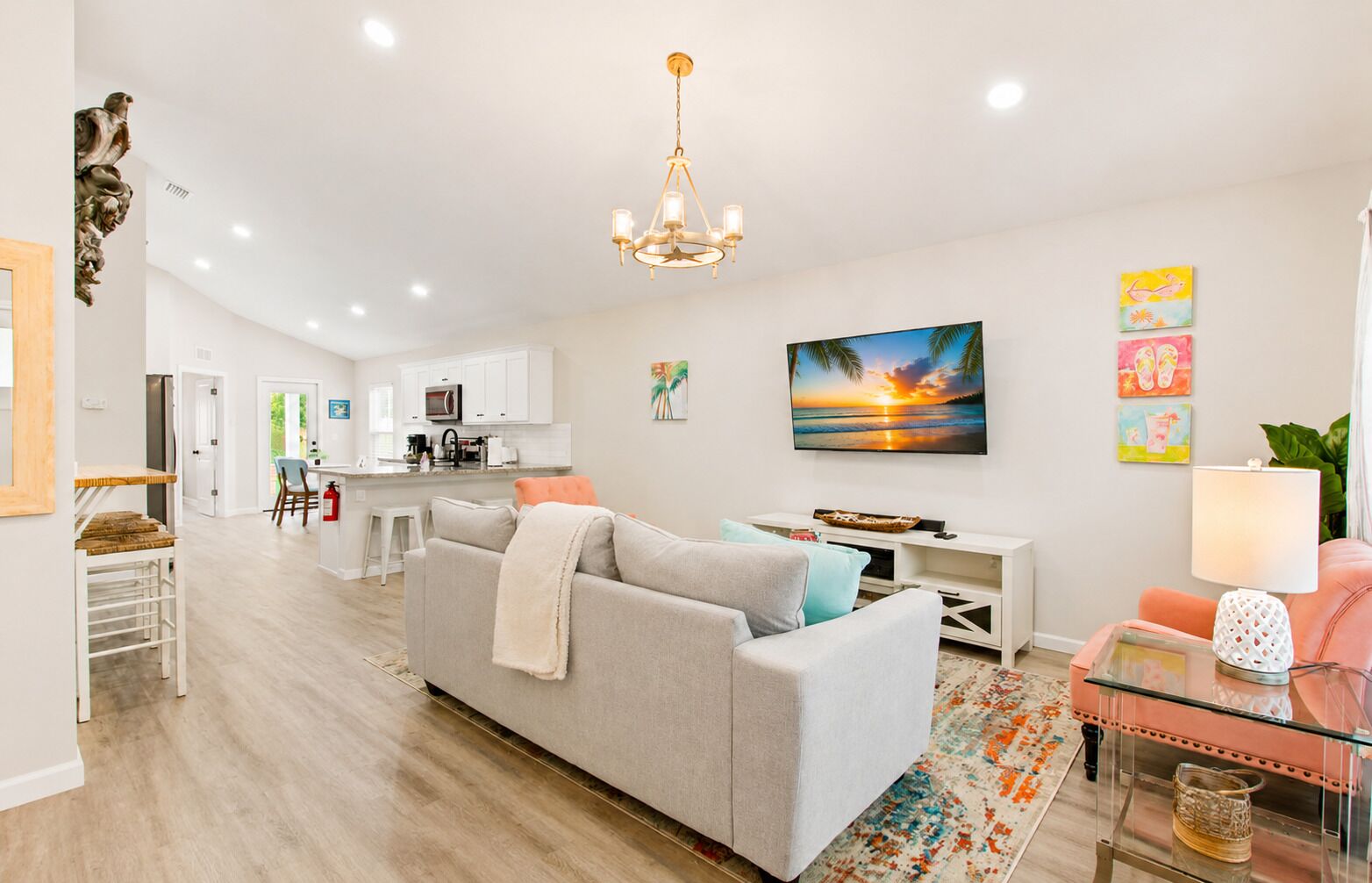 A modern living room with a sofa, a TV, and a dining area.