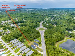 An aerial view of a residential area with a road leading to Historic Downtown and St Augustine Beach, 2.3 miles away.