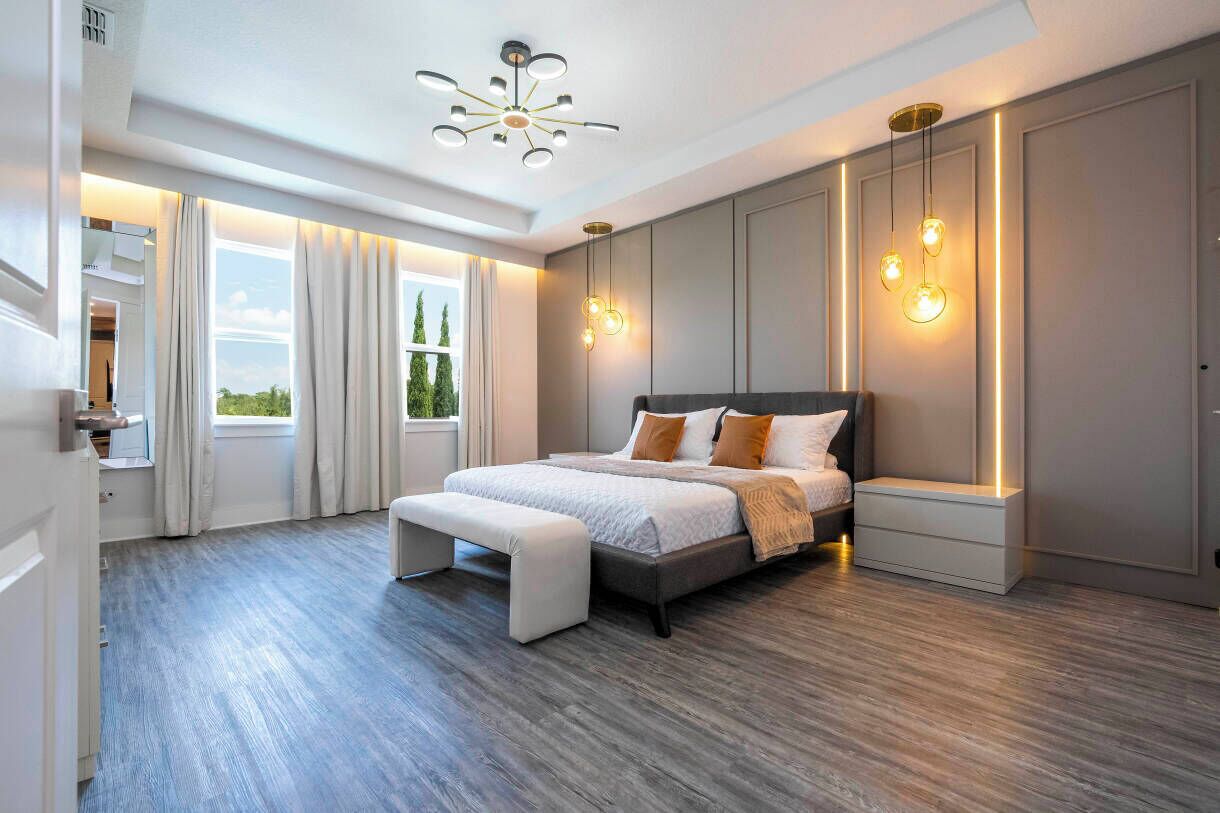 Une chambre moderne avec un grand lit, des lampes de chevet et une vue sur la verdure.