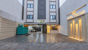 A hotel entrance with a 'treebo' sign, a 'Hotel Oscar' sign, and a check-in counter. - Treebo Oscar (Rajkot)