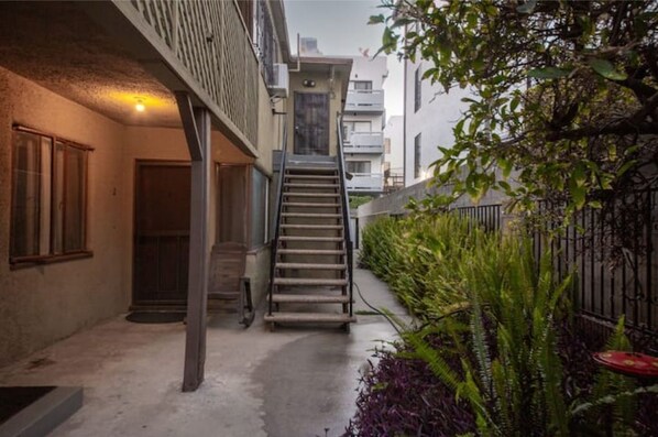 Staircase leads to a residential building with a simple, utilitarian design.