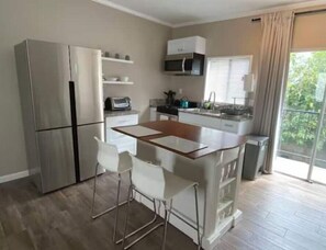 Enjoy cooking in this well-equipped kitchen with a central island, stainless steel appliances, and oven.