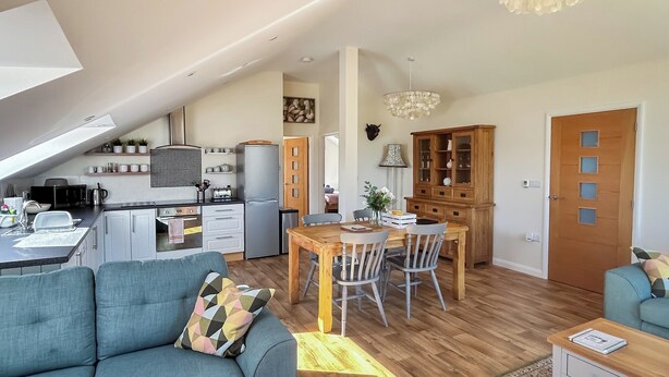 A modern apartment with a kitchen, dining area, and living room. - 2 bedroom accommodation in Coxley Wick, near Wells (Coxley Wick, near Wells)