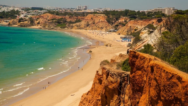 A coastal beach with clear turquoise waters, sandy shores, and rocky cliffs. - Falesia Beach C at Falesia Beach (Albufeira)