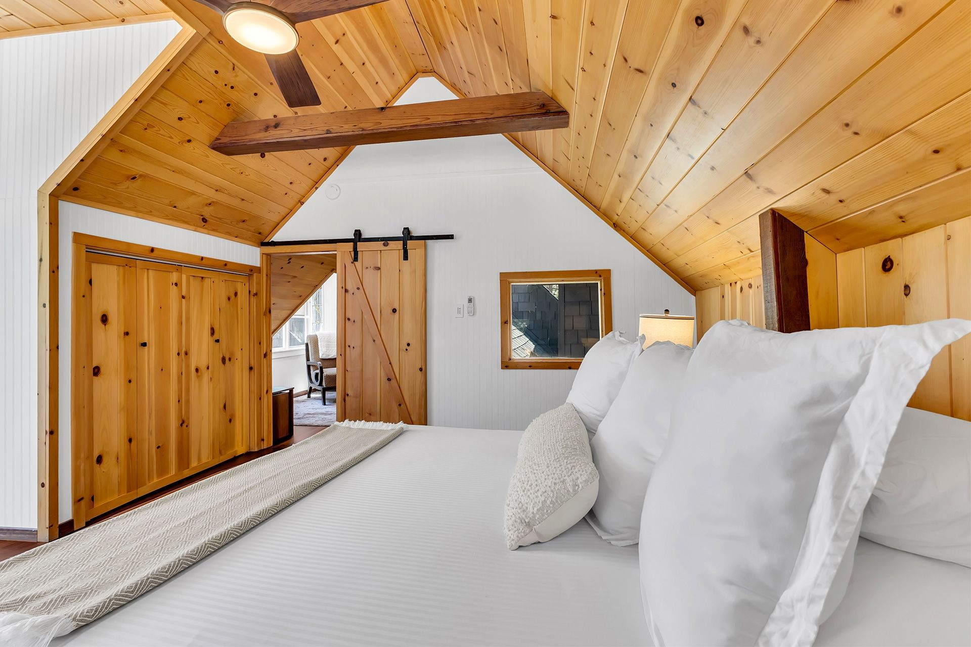 Cozy bed detail in rustic master bedroom