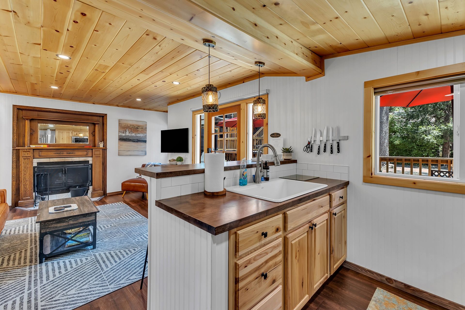 A modern kitchen with wooden cabinets, a large island, and a built-in oven.