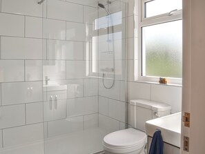 A modern bathroom with a glass shower enclosure, a toilet, and a sink. - You will love this spacious semi-detached dormer bungalow with enclosed garden. (Flamborough, near Bridlington)