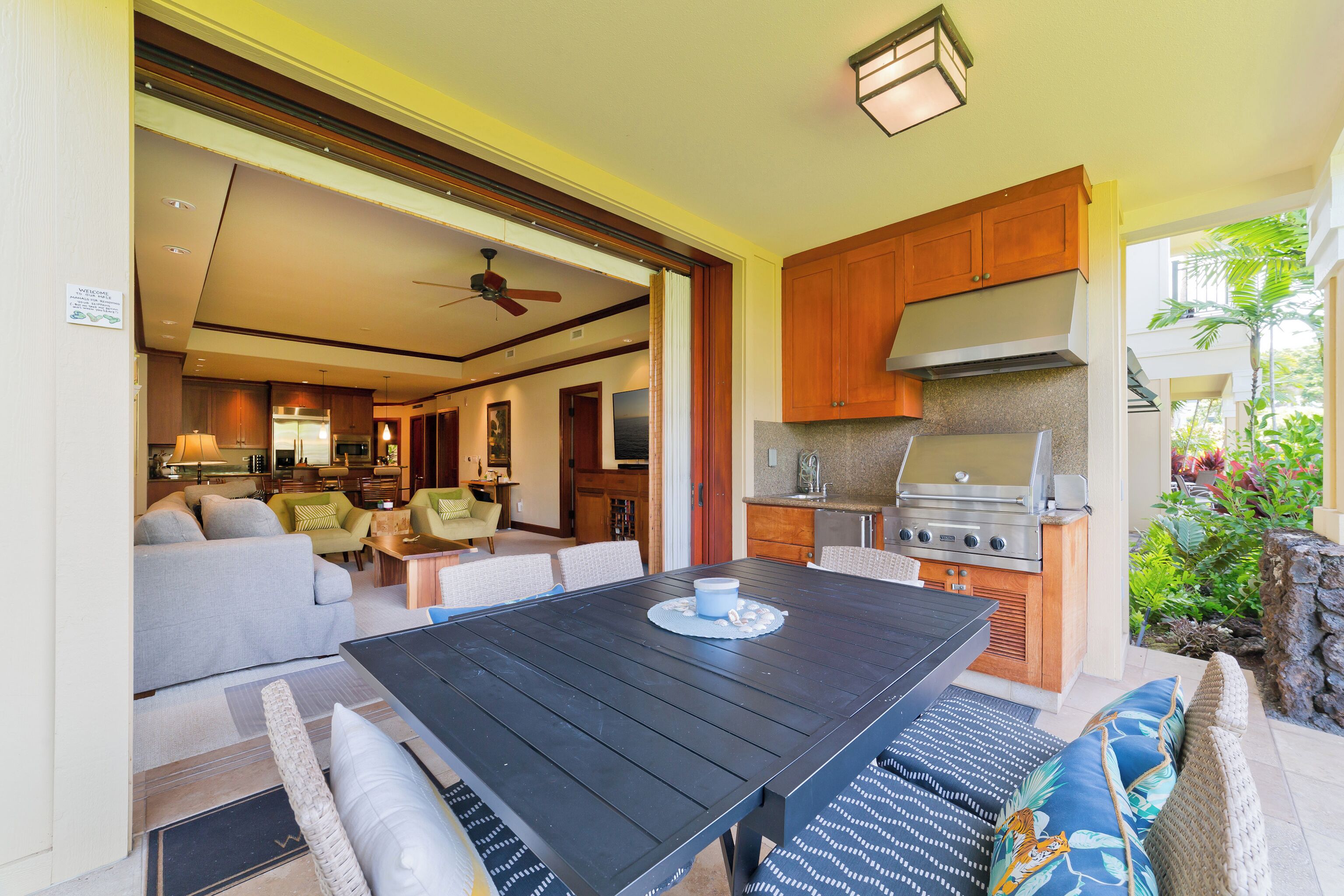 An open-plan living and dining area with a kitchen, a dining table, and a sofa.