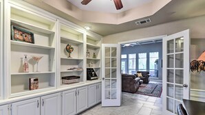 A spacious living area with a large open door leading to a balcony, white cabinetry with glass doors, and a marble floor. - Come see why Granbury is Texas' best kept secret! Unwind at La Paloma - Enjoy!  (Granbury)