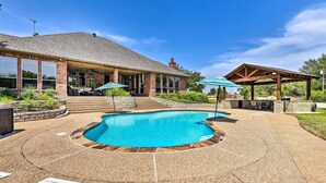 A backyard with a swimming pool, patio furniture, and a covered seating area. - Come see why Granbury is Texas' best kept secret! Unwind at La Paloma - Enjoy!  (Granbury)