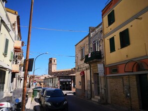A narrow street with buildings on both sides, a visible sign for 'SANTA CHARA', and a tower-like structure in the background. - B&B La Fabbrica di San Pietro (Vasto)