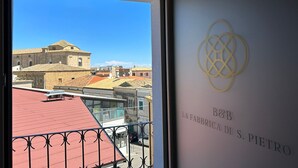 A view from a balcony with a building in the background and a sign with "B&B LA FABBRICA DI S. PIETRO" on the wall. - B&B La Fabbrica di San Pietro (Vasto)